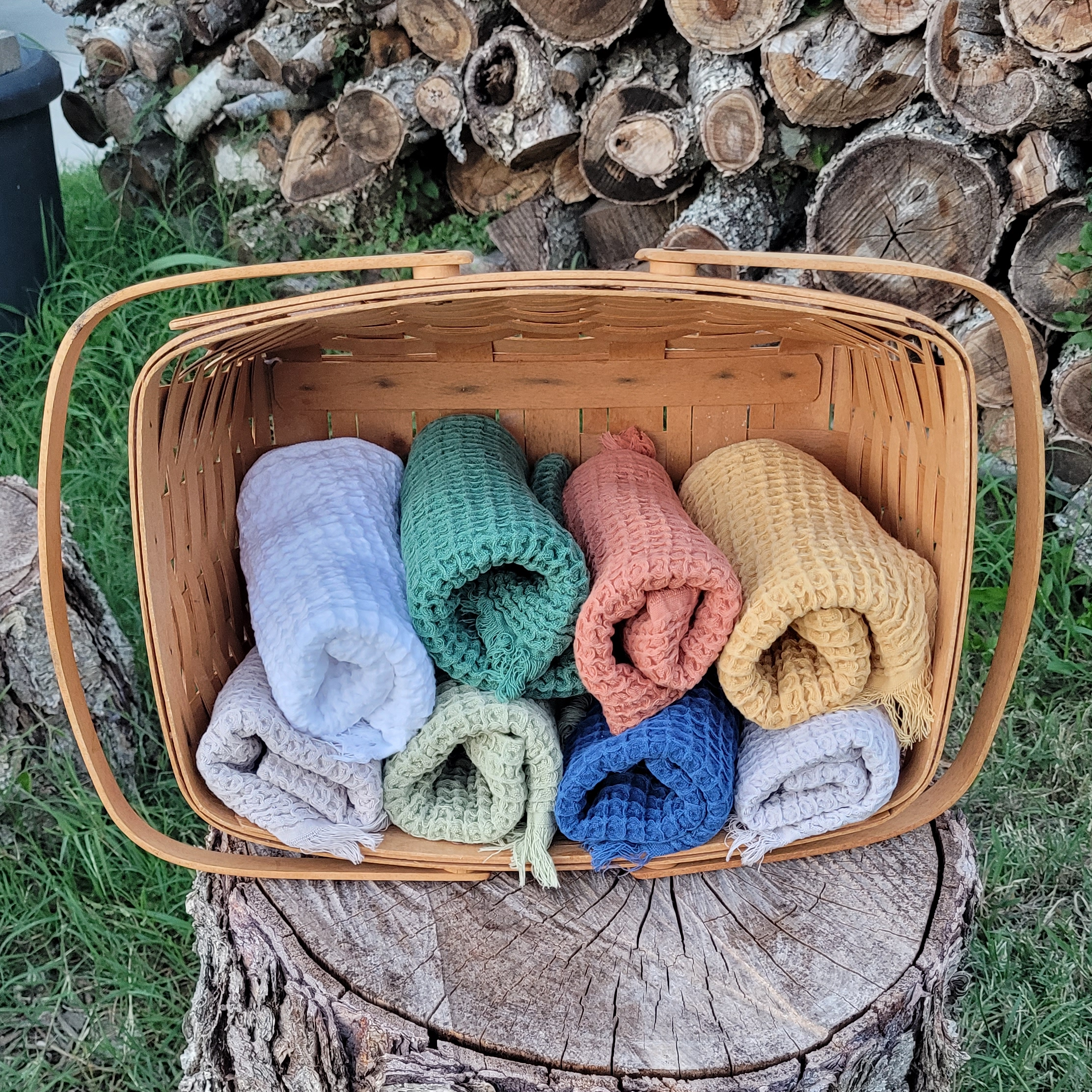 Waffle weave hand towels in nine colors, rolled and labeled